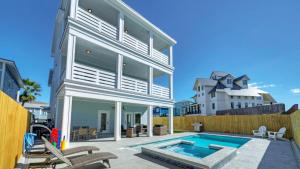 a home with a swimming pool and a house at Private PoolHot Tub Near the Beach Gulf Glimpse Marlin Cove by AvantStay in Port Aransas