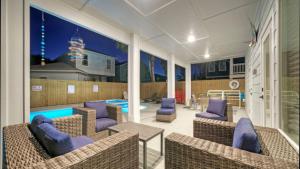 a patio with wicker chairs and a swimming pool at Private PoolHot Tub Near the Beach Gulf Glimpse Marlin Cove by AvantStay in Port Aransas