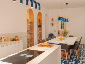 a kitchen and dining room with a table and chairs at Maison Resaurie - Hôtel in Biarritz +23 photos