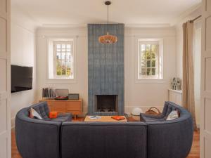 a living room with a couch and a fireplace at Maison Resaurie - Hôtel in Biarritz