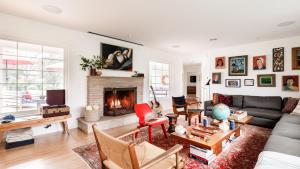 a living room with a couch and a fireplace at Marquee By AvantStay Modern Stylish Estate w Pool Entertainers Courtyard in Boyes Hot Springs