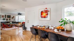 a dining room and living room with a table and chairs at Marquee By AvantStay Modern Stylish Estate w Pool Entertainers Courtyard in Boyes Hot Springs