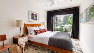 a bedroom with a bed and a large window at Marquee By AvantStay Modern Stylish Estate w Pool Entertainers Courtyard in Boyes Hot Springs +25 photos