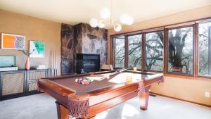 a living room with a pool table andwindows at Gable by AvantStay Beautiful 3.5 Acre Oasis w Gorgeous Views Pool Hot Tub in Santa Rosa