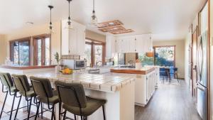 a kitchen with a large island with bar stools at Gable by AvantStay Beautiful 3.5 Acre Oasis w Gorgeous Views Pool Hot Tub in Santa Rosa