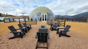 a group of chairs in front of a dome tent at The Nest at Black Hawk in Black Hawk