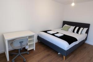 a bedroom with a bed with a desk and a bed sidx sidx sidx at Morris lodge in Dartford