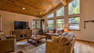 a living room with couches and a flat screen tv at Moosetrack by AvantStay Cozy Cabin w Hot Tub In The Heart of Tahoe Donner in Truckee