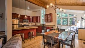 a kitchen and dining room with a table and a couch at Moosetrack by AvantStay Cozy Cabin w Hot Tub In The Heart of Tahoe Donner in Truckee