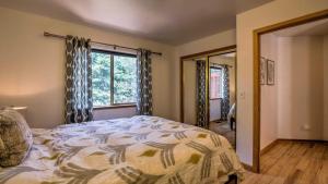 a bedroom with a bed and a large window at Moosetrack by AvantStay Cozy Cabin w Hot Tub In The Heart of Tahoe Donner in Truckee +15 photos