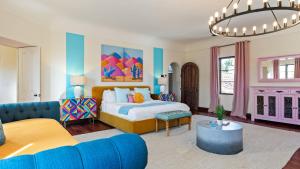 a bedroom with a bed and a living room at Luxe 7BDR Oasis w Pool Putting Green Game Room Villa Del Gallo by AvantStay in Bermuda Dunes +92 photos