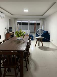 a living room with a wooden table and chairs at In mare Bali Resort in Parnamirim