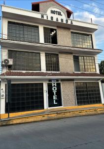 a hotel building with a sign on the front of it at Hotel MIRANDA in Tapachula