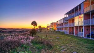 a view of a building with the sunset in the background at Studio w Balcony Pools Direct Beach Access Seaside Blessing by AvantStay in Port Aransas