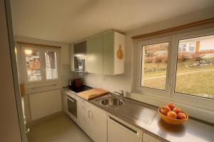 a kitchen with a bowl of fruit on the counter at Chalet Alpenheim 2 OG in Bettmeralp