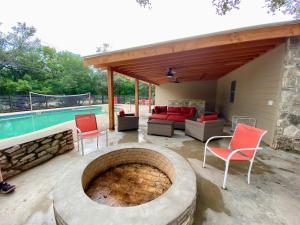 a patio with a fire pit next to a pool at Casa Floerke in Concan