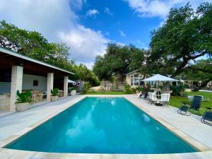 a swimming pool in a yard with a house at Agave Point in Concan