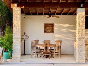 a wooden table and chairs on a patio at Agave Point in Concan