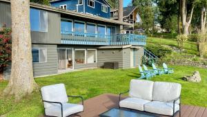 a group of chairs sitting on a patio in front of a house at Saratoga by the Sea by AvantStay Panoramic View Near Langley in Langley