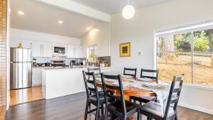 a kitchen and dining room with a table and chairs at Saratoga by the Sea by AvantStay Panoramic View Near Langley in Langley