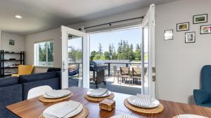 a living room with a table with hats on it at Twin Oaks Retreat by AvantStay Mins to Freeland in Langley
