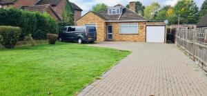 a van parked in the driveway of a house at Andover Bungalow in Penton Mewsey +8 photos