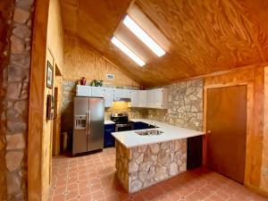 a kitchen with a stove and a refrigerator at Kickin Back in Concan