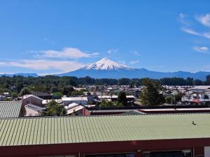 a view of a snow covered mountain in a city at Departamento Villarrica in Villarrica