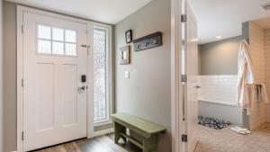 a bathroom with a white door and a tub at Harrington Hideaway by AvantStay Beach Access in Coupeville +33 photos