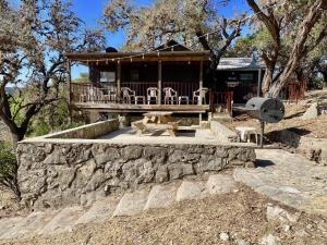 a house with a porch with chairs on it at On the Rocks! in Concan