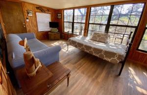 a living room with a bed and a couch at On the Rocks! in Concan