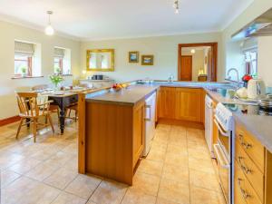 a large kitchen with a table and a dining room at 2 Bed in Clynderwen 82445 in Clynderwen