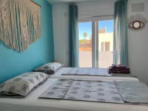 two beds in a room with a window at Villa Domicil de Luxe in Torrevieja +82 photos