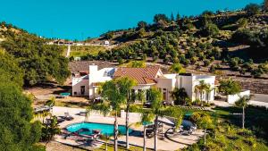 an aerial view of a house with a swimming pool at Grapevine by AvantStay Secluded 5BR Villa 4 Acres of Vineyards Avo Groves in Temecula