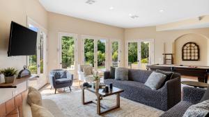 a living room with a couch and a pool table at Grapevine by AvantStay Secluded 5BR Villa 4 Acres of Vineyards Avo Groves in Temecula