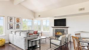 a living room with a couch and a fireplace at Hilltop by AvantStay Countryside Escape w Views in Paso Robles