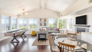 a living room with a pool table and a fireplace at Hilltop by AvantStay Countryside Escape w Views in Paso Robles