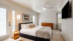 a bedroom with a bed and a flat screen tv at Hilltop by AvantStay Countryside Escape w Views in Paso Robles