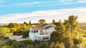 an aerial view of a white house with a porch at Hilltop by AvantStay Countryside Escape w Views in Paso Robles