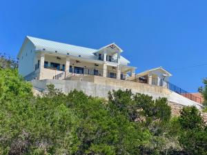 a house on top of a hill with trees at Pretty Penny in Concan