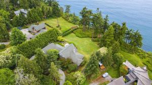 an aerial view of a house on a hill near the water at Goldilocks by AvantStay Luxury Waterfront Home in Greenbank