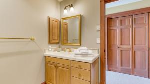 a bathroom with a sink and a mirror at Goldilocks by AvantStay Luxury Waterfront Home in Greenbank