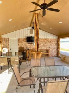 a dining room with tables and chairs and a ceiling fan at North Star in Concan