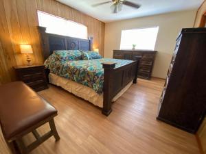 a bedroom with a bed and a chair and two windows at North Star in Concan +36 photos