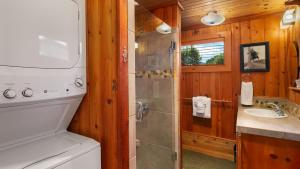 a bathroom with a shower and a toilet and a sink at The Pilot House by AvantStay Stunning Home Right On Arch Cape Beach in Arch Cape +17 photos