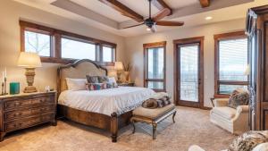 a bedroom with a bed and a chair and windows at Heritage by AvantStay Luxe Oregon Retreat Deck in Powell Butte