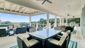 a patio with a table and chairs on a deck at 3100 Palm Boulevard by AvantStay Beachfront Ocean Views Private Pool in Isle of Palms