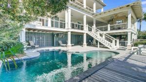 a house with a swimming pool in front of a house at 3100 Palm Boulevard by AvantStay Beachfront Ocean Views Private Pool in Isle of Palms