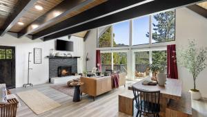 a living room with a couch and a fireplace at Hot Tub Fire Pit Deck Views Near the Lake The Matterhorn Manor by AvantStay in Crestline