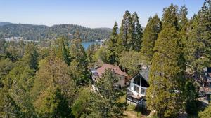 an aerial view of a house in the trees at Hot Tub Fire Pit Deck Views Near the Lake The Matterhorn Manor by AvantStay in Crestline